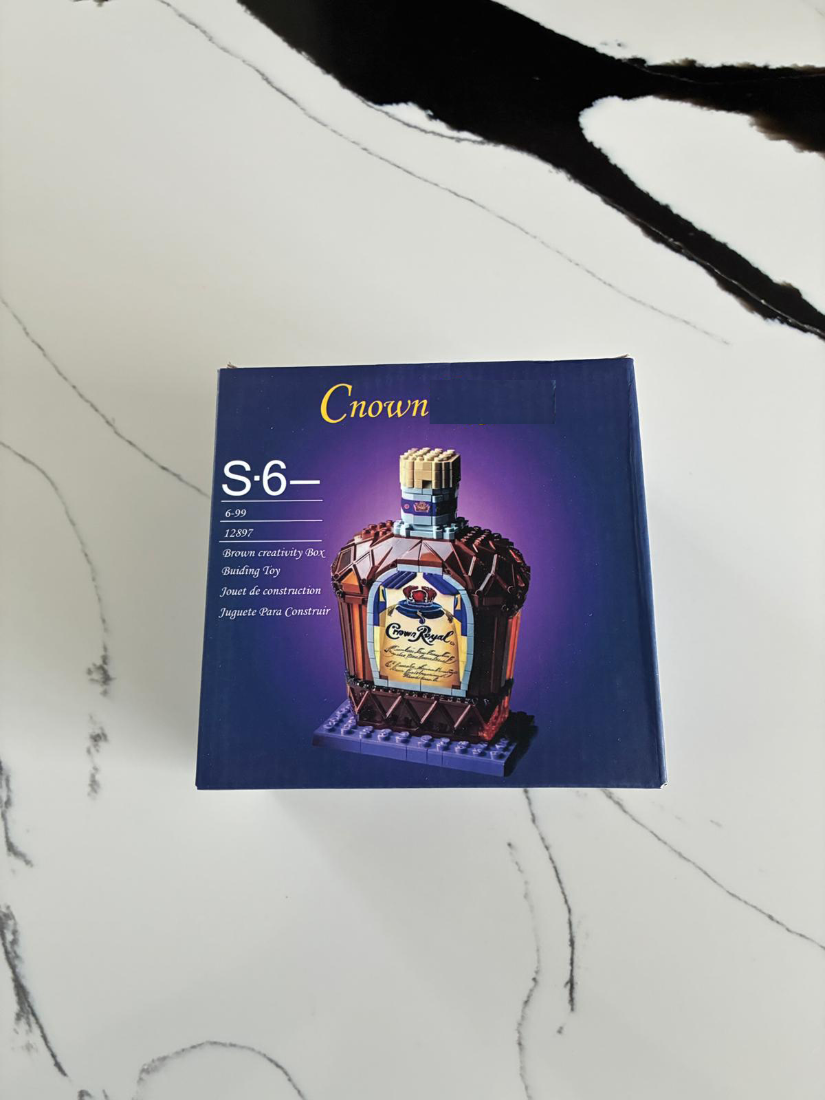 Crown Premium Gold Bottle building block model displayed on shelf and desk